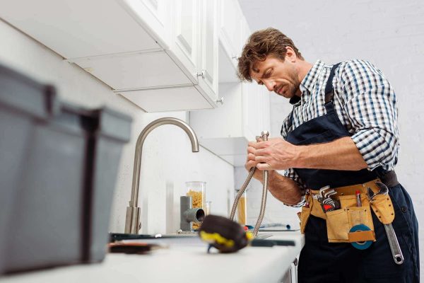 selective-focus-of-plumber-holding-metal-pipe-near-resize.jpg