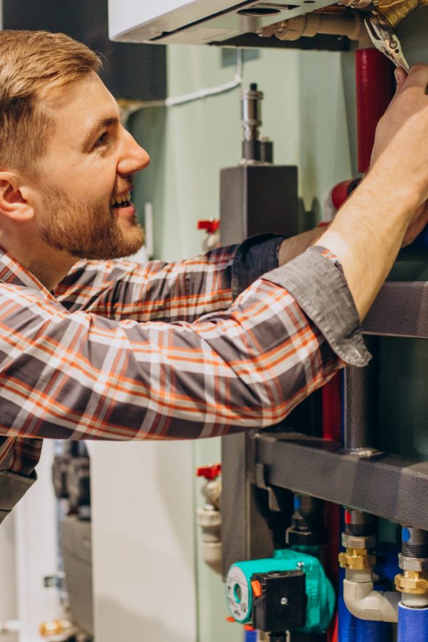 Young engineer adjusting autonomous heating